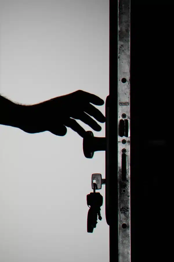 Person opening a door.