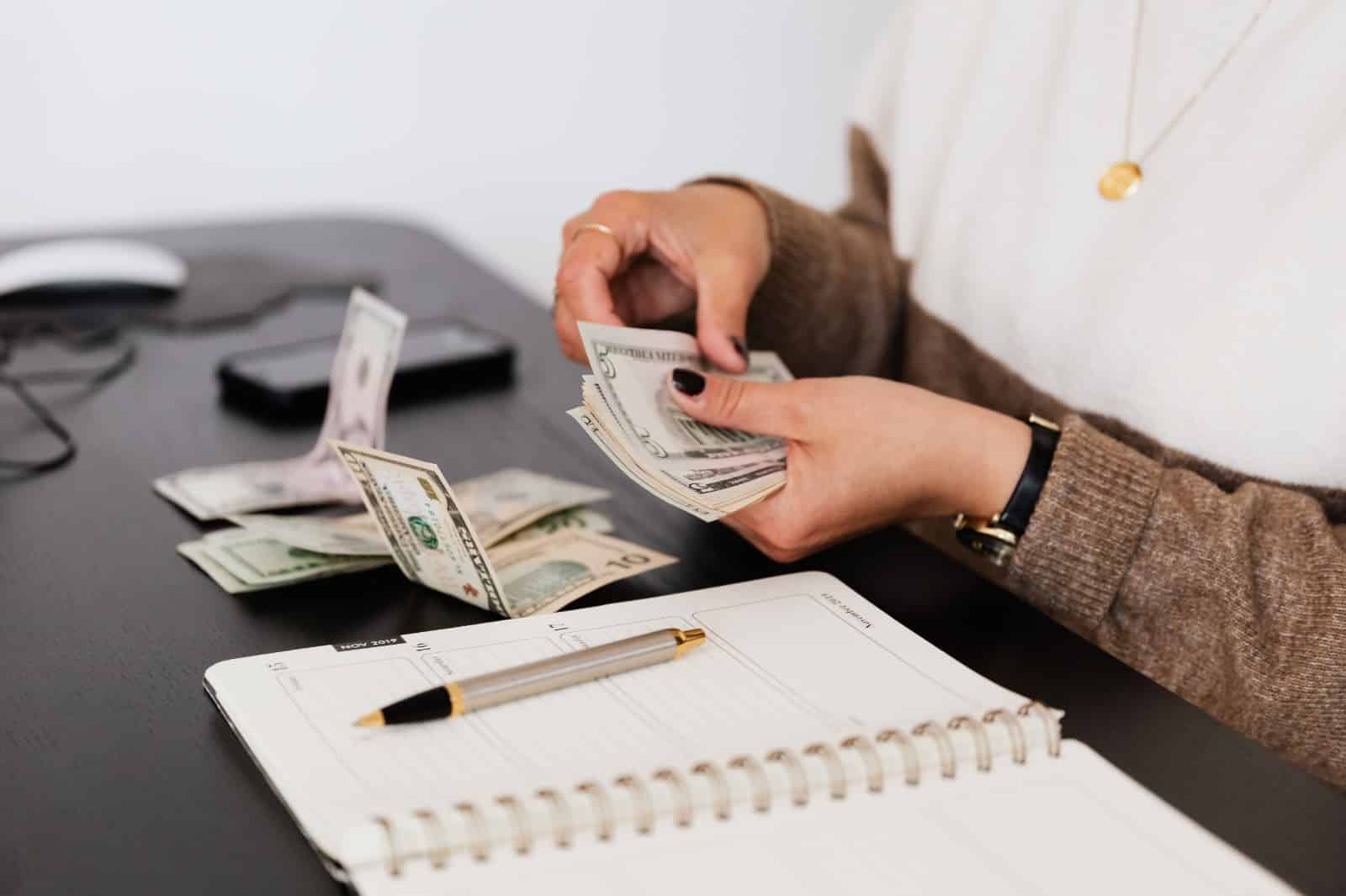 Person counting money to figure out how much bail is.